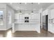 Modern white kitchen with quartz countertops, stainless steel appliances, and an island at 206 W Respite Ln, Summerville, SC 29483