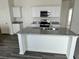 Kitchen island with granite countertop, stainless steel sink, and white cabinets at 218 Phoenix Dr, Summerville, SC 29486