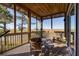 Relaxing screened porch with wooden Adirondack chairs overlooking marsh views at 234 Old House Lane, 1/4 Share, Dewees Island, SC 29451