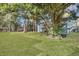 Large backyard with a grassy lawn, trees, and a storage shed at 2675 Houston St, North Charleston, SC 29405