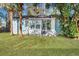 Backyard with grassy lawn, palm trees, and a sunroom addition at 2675 Houston St, North Charleston, SC 29405