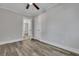 Empty bedroom with gray walls, wood-look flooring, and open door to another room at 2675 Houston St, North Charleston, SC 29405