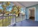 Covered front porch with white railing and steps leading to a grassy yard at 2675 Houston St, North Charleston, SC 29405