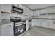 Modern kitchen featuring stainless steel appliances, white cabinetry, and granite counters at 2675 Houston St, North Charleston, SC 29405