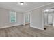 Bright living room with wood-look flooring, neutral paint, and multiple windows at 2675 Houston St, North Charleston, SC 29405