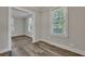 Bright living area with wood-look floors and openings to adjacent rooms at 2675 Houston St, North Charleston, SC 29405