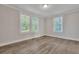 Spacious living area with wood-look floors, abundant natural light, and neutral walls at 2675 Houston St, North Charleston, SC 29405