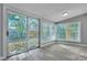 Sliding door opens to the backyard from this bright sunroom with many windows at 2675 Houston St, North Charleston, SC 29405