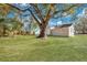 Spacious backyard with a large tree, grassy area, and a view of the house at 2754 Houston St, North Charleston, SC 29405