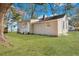 Exterior view of the house with a grassy backyard and a large tree at 2754 Houston St, North Charleston, SC 29405