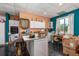 Second kitchen with white cabinets, island, teal accent wall, and tile floor at 280 Royalegates Ct, Cross, SC 29436