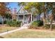 Inviting front yard with a brick pathway leading to a charming blue two-story home with a covered porch at 3699 Codorus Ct, Mount Pleasant, SC 29466