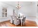 Elegant dining room with a chandelier, white wainscoting, and hardwood floors at 42 Isle Of Hope Rd, Mount Pleasant, SC 29464