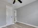 Gray bedroom with ceiling fan, open door, and wood-look floors at 442 Annette Dr, Goose Creek, SC 29445