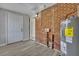 Laundry room with brick accent wall, water heater, and exterior access at 442 Annette Dr, Goose Creek, SC 29445