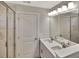 Modern bathroom boasts a marble tiled shower, dual vanity, and plenty of light at 518 Fleming Rd, Charleston, SC 29412