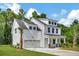 White two-story home with dark gray roof, attached garage, and landscaped yard at 518 Fleming Rd, Charleston, SC 29412