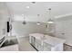 Bright, open kitchen featuring white cabinets, an island with a farmhouse sink, and modern appliances at 518 Fleming Rd, Charleston, SC 29412