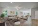 Staged living room with modern furniture and decor, open to the dining area at 518 Fleming Rd, Charleston, SC 29412