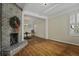 Dining room with hardwood floors, brick fireplace, and holiday wreath at 56 Gibbes St # A, Charleston, SC 29401