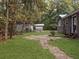 Backyard with storage sheds, patio area, and grassy lawn at 6713 Augusta Hwy, Smoaks, SC 29481