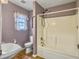 Bathroom with a white bathtub, toilet, and corner shelf, featuring purple walls at 6713 Augusta Hwy, Smoaks, SC 29481