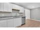 Updated kitchen featuring white shaker cabinets, granite countertops, and a stainless steel sink at 7731 Barclay Ave, North Charleston, SC 29418