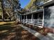 Covered front porch, white railing, and landscaping welcome you home at 923 Godber St, Charleston, SC 29412