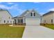 Charming blue two-story home with a brick and siding facade and attached garage at 112 Crosscut Ln, Summerville, SC 29486