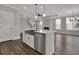 Open-concept kitchen with island, stainless steel appliances, and view of living area with fireplace at 112 Crosscut Ln, Summerville, SC 29486