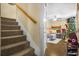 Carpeted stairway leading to a living room with holiday decorations and a bicycle at 120 Luden Dr # C, Summerville, SC 29483