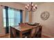 Dining room with wood table and chairs, shiplap wall, and chandelier at 129 W Hartwick Ln, Goose Creek, SC 29445