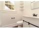 Clean and simple bathroom with white vanity, barn door style cabinet, and modern fixtures at 1808 Calvert St, North Charleston, SC 29405