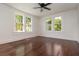 A spacious, light-filled bedroom with gleaming hardwood floors and several windows at 1808 Calvert St, North Charleston, SC 29405