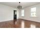 Dining room with gleaming hardwood floors, white walls, and a modern light fixture at 1808 Calvert St, North Charleston, SC 29405