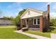 Charming red brick home with white trim, covered porch and lush green lawn at 1808 Calvert St, North Charleston, SC 29405