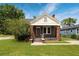 Charming brick home with a covered front porch and landscaped yard at 1808 Calvert St, North Charleston, SC 29405