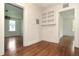 Hallway with built-in shelving connecting to other rooms with hardwood floors at 1808 Calvert St, North Charleston, SC 29405