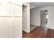 Hallway with white paneled walls and wood-style flooring leading to additional rooms at 1808 Calvert St, North Charleston, SC 29405