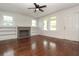 Living room with fireplace, built-in bookshelves, and gleaming hardwood floors at 1808 Calvert St, North Charleston, SC 29405