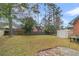 Fenced backyard with a storage shed, grassy area, and trees at 202 Telfair Ct, Summerville, SC 29485