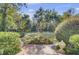 Landscaped backyard with fountain and brick pathway at 208 Sumter Ave, Summerville, SC 29483