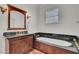Bathroom with soaking tub and dark granite countertops at 208 Sumter Ave, Summerville, SC 29483