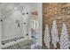 Spa-like bathroom with a walk-in shower, exposed brick, and geometric tile floor at 208 Sumter Ave, Summerville, SC 29483