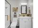 Clean bathroom with white vanity and tin backsplash at 208 Sumter Ave, Summerville, SC 29483
