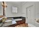 Bathroom with soaking tub and dark granite countertops at 208 Sumter Ave, Summerville, SC 29483