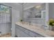 Bathroom with marble countertop, gray cabinets, and an ornate mirror at 208 Sumter Ave, Summerville, SC 29483