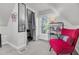 Attic bedroom with twin beds, red chair and ample natural light at 208 Sumter Ave, Summerville, SC 29483