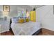 Main bedroom with comfortable bed, yellow dresser, and barn door at 208 Sumter Ave, Summerville, SC 29483