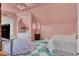Charming bedroom with a blush pink color scheme, built-in daybed, and green flooring at 208 Sumter Ave, Summerville, SC 29483